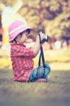 Asian Girl Taking Photos Using Vintage Film Camera In Garden. Vi Stock Photo