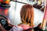 Beautiful Girl In An Electric Bumper Car In Amusement Park Stock Photo