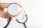 Hand On Stethoscope On White Background Stock Photo