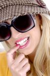 Smiling Female Biting Nail Stock Photo