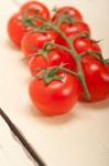 Fresh Cherry Tomatoes On A Cluster Stock Photo