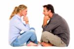 Couple Sitting Face To Face Stock Photo