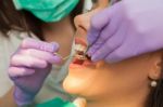 Dentist Examining A Patient's Teeth In The Dentist Stock Photo