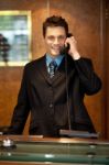 Male Receptionist Talking Phone Stock Photo