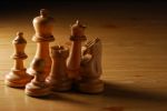 Wooden Chess Pieces On Wooden Table Stock Photo