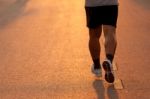 Feet Of Runner In Evening Light Stock Photo