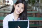 Portrait Of Thai Student Teen Beautiful Girl Using Her Tablet Stock Photo