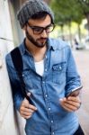 Modern Young Man With Mobile Phone In The Street Stock Photo