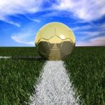 Golden Soccer Ball In Grass Stock Photo