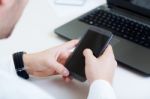 Young Handsome Man Working In His Office With Mobile Phone Stock Photo