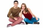 Adorable Young Lovers Sitting On The Floor Stock Photo