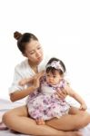 Mom Is Holding And Playing With Her Baby On White Background Stock Photo