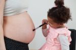 Pregnant Woman And Her Daughter Stock Photo