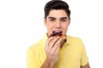 Handsome Guy Enjoying Yummy Pizza Slice Stock Photo