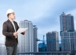 Engineering Man Wearing Western Suit And Safety Helmet With Buil Stock Photo