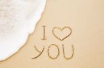 I Love You Written On Wet Yellow Beach Sand Stock Photo