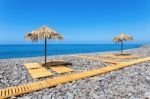 Beach Umbrellas With Path And Stones At Portuguese Sea Stock Photo