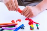 Child Molding Modeling Clay, On White Background. Strengthen The Imagination Stock Photo