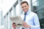 Cheerful Entrepreneur Reading Newspaper Stock Photo