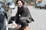 Businessman Repairing Car Roadside Stock Photo