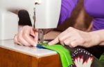 Woman's Hands Sewing On The Sewing Machine Stock Photo