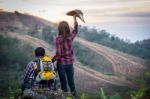 Female Tourists And Men Are Viewing The Mountain Stock Photo