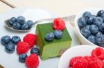 Green Tea Matcha Mousse Cake With Berries Stock Photo