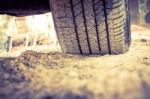 Closeup Car Tire On The Ground. Wheel Tracks On Dirt. Vintage Pi Stock Photo