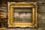 Big Old Gold Picture Frame On Wooden Background Stock Photo