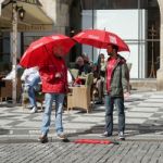 Tour Guides Waiting For Customers In The Old Town Square In Prag Stock Photo