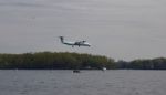 Photo With The Landing Blue Plane And The Lake Stock Photo