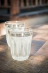 Double Glasses Of Cold Water On Wooden Table Stock Photo