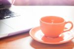 Coffee Cup With Keyboard On Wooden Table Stock Photo