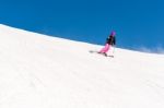 Female Skier In Fresh Powder Snow And Blue Sky Stock Photo