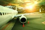 Pasenger Plane Parking On Airport Runnway Against Beautiful Sun Rising Sky Use For Traveling Buisiness And Air Transportation Theme Stock Photo