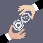 Two Businessman Hands With Gears Stock Photo