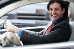 Cheerful Man Driving His New Luxurious Car Stock Photo