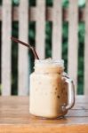 Glass Of Iced Coffee On Wooden Table With Vintage Filter Style Stock Photo