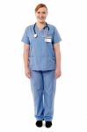 Beautiful Female Doctor Standing Against White Stock Photo