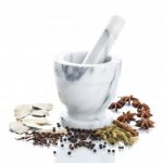 Marble Mortar And Pestle With Assorted Spices On White Backgroun Stock Photo