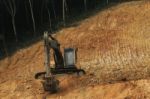 Heavy Road Construction Machine Working On Hill Slope Stock Photo