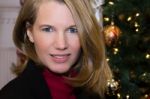 Closeup Of Blonde Female And Christmas Tree Stock Photo