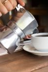 Hand On Traditional Italian Moka Pot Stock Photo