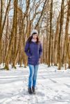 Young Beautiful Woman In The Woods In Winter Stock Photo