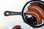 Beef Sausages Cooked On Iron Skillet Stock Photo