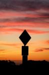 Road Sign Silhouette And Colorful Sunset Stock Photo