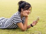 Woman Relaxing And Listening To Music Outdoors Stock Photo