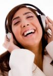 Portrait Of Smiling Young Female Enjoying Music Stock Photo