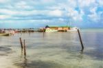 Wooden Pier Dock, Boats And Ocean View At Caye Caulker Belize Ca Stock Photo