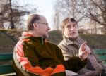 Two Elderly Men Talk On A Park Bench Stock Photo